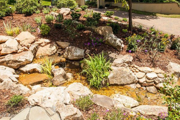 small rock pond residential landscaping
