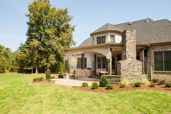 outdoor fireplace area with landscaping