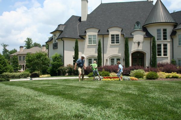 family playing in beautiful front lawn