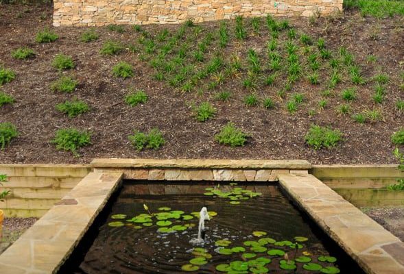 Japanese-style landscape with pond and natural stone hardscaping in Charlotte