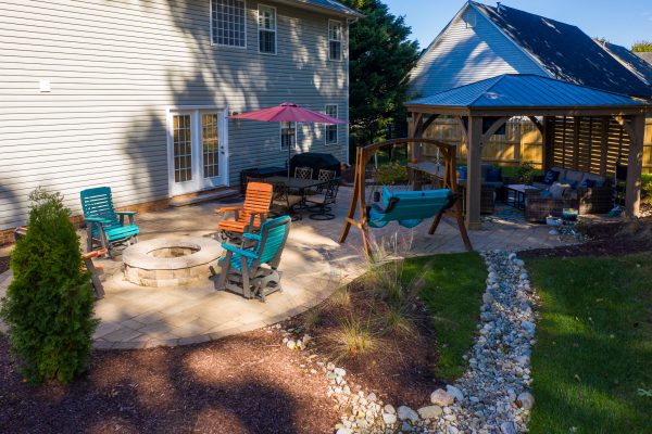 Outdoor living space with custom patio and drainage Huntersville NC | MetroGreenscape