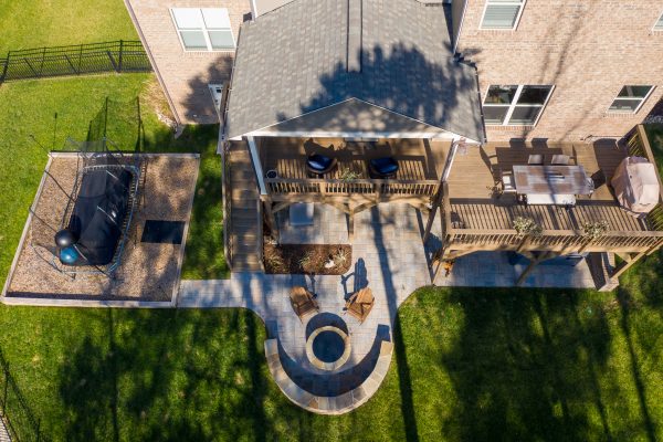 Second story deck with a MetroGreenscape patio and seating area beneath in Huntersville NC