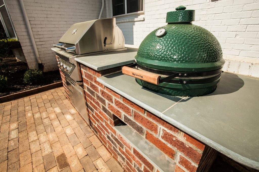 Brick outdoor kitchen with a grill and Big Green Egg