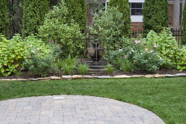 Custom landscaping by MetroGreenscape with a center fountain in North Carolina