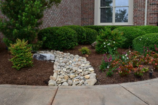 Water redirection with stones in Charlotte NC, drainage by MetroGreenscape
