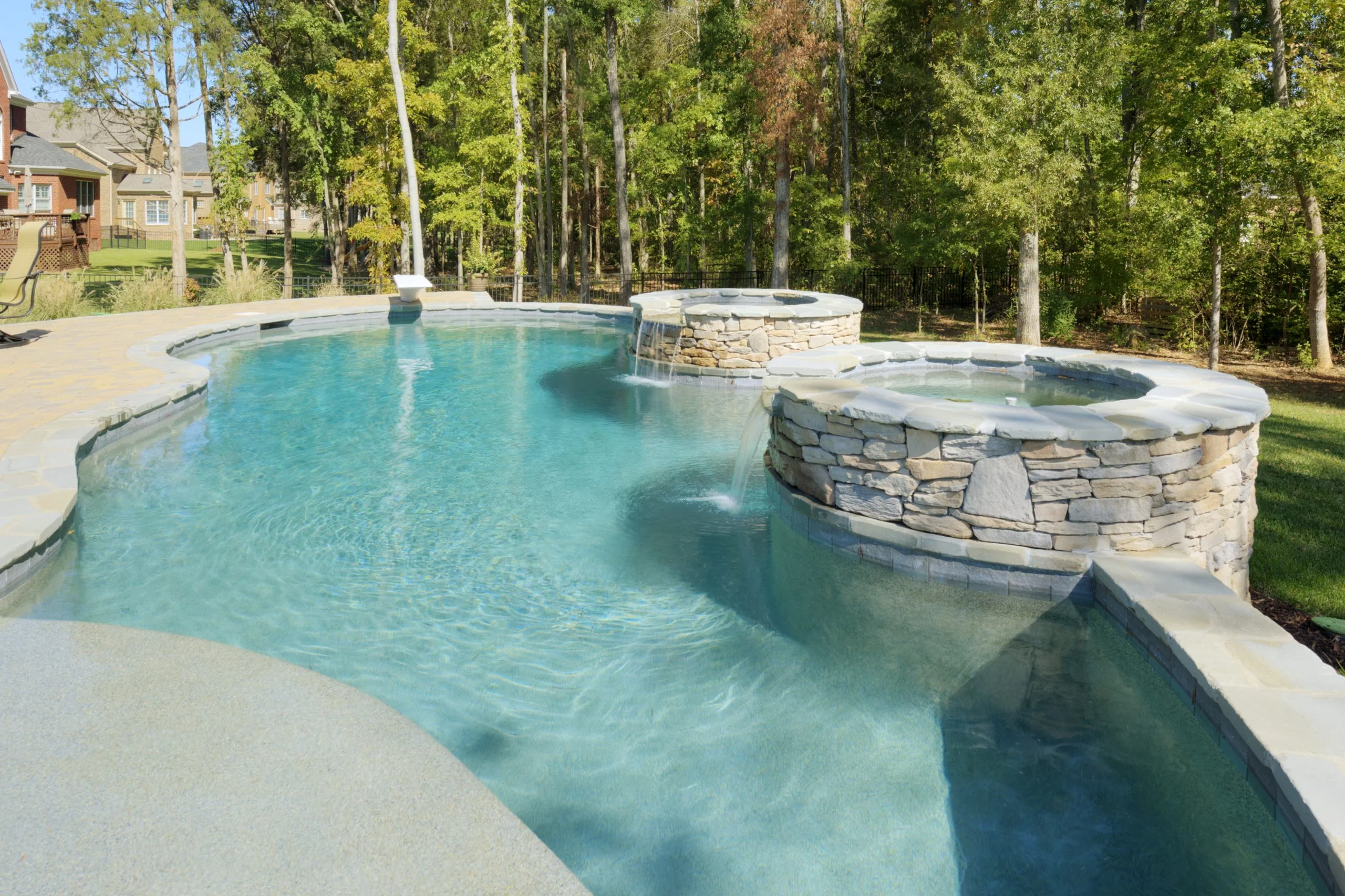 Pool with water features designed by MetroGreenscape