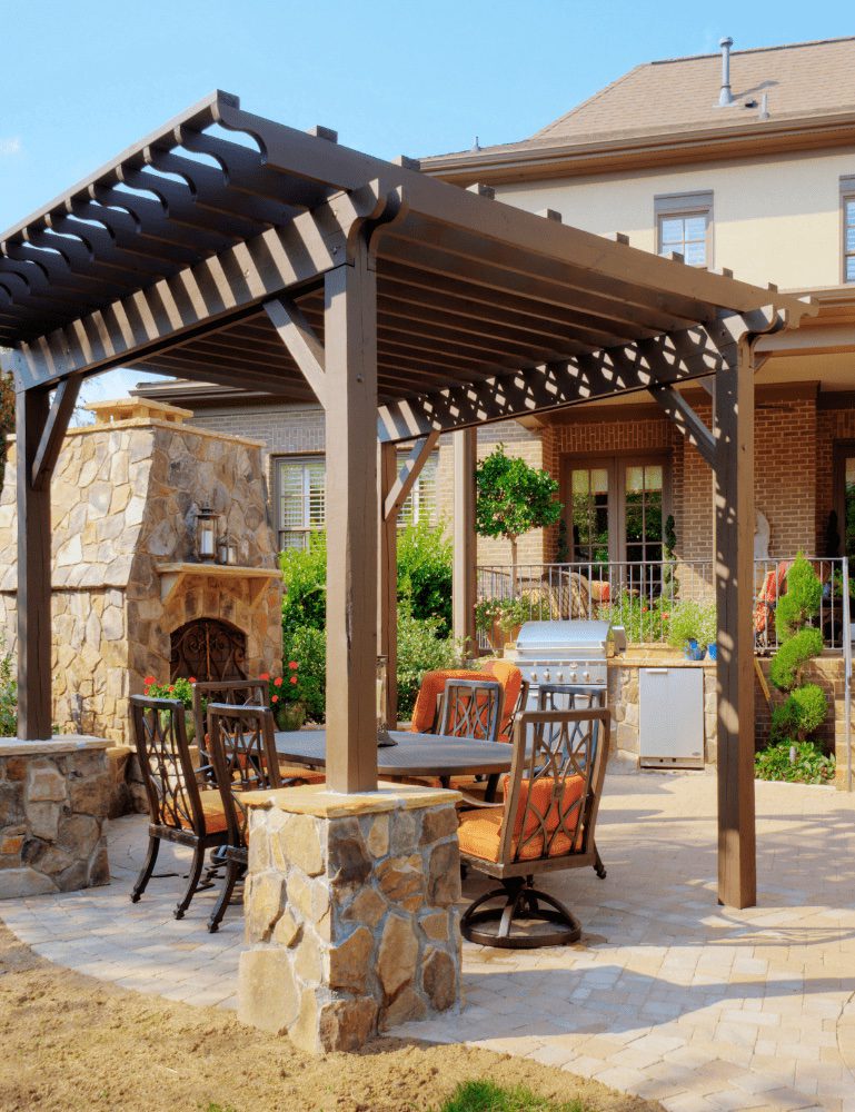 Outdoor living area with seating, fireplace and grill/fridge